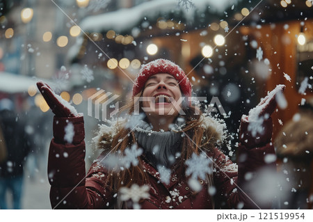 Joyful woman tossing snowflakes at a vibrant christmas market scene 121519954