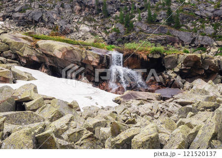 Waterfall among boulders in remote mountains. Waterfall among boulders in remote mountains. 121520137