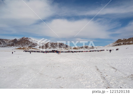 More tourists on a snowy slope to distance. More tourists on a snowy slope to distance. 121520138