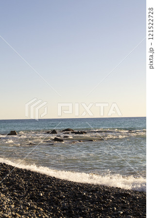 Splashes from the waves bumping against the rocky shore. Vertical photo 121522728