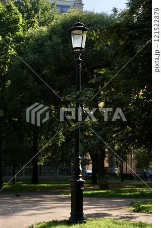 Vintage glass street lamp, lantern on high pole in park. Ideal for historical architecture 121522879
