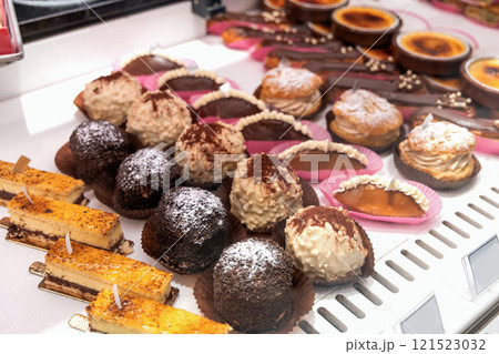 Various assortment of desserts confectionery on the counter in a bakery Various assortment of desserts confectionery on the counter in a bakery 121523032