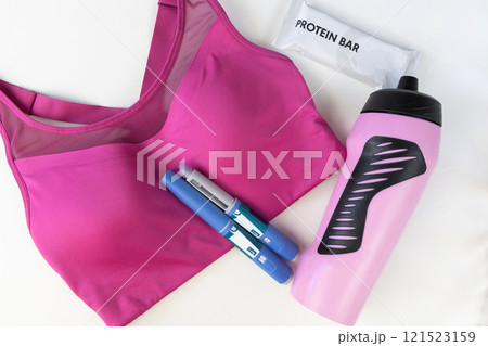 Concept of losing weight with the diabetes drug Ozempic. Sports top and Ozempic syringe pen. 121523159