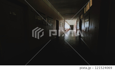Dimly lit school hallway after the last school day, evoking a sense of nostalgia, memories, and the passage of time Dimly lit school hallway after the last school day, evoking a sense of nostalgia, memories, and the passage of time 121524069