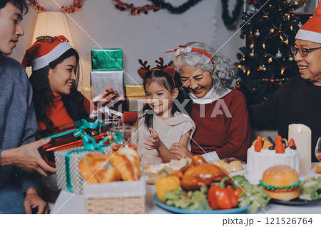 Happy family with gifts celebrating Christmas together 121526764
