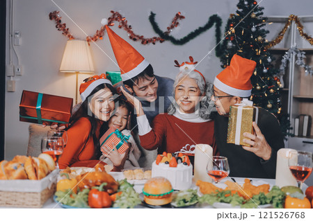 Happy family with gifts celebrating Christmas together 121526768