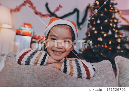 christmas, x-mas, winter, happiness concept - dreaming girl in santa helper hat christmas, x-mas, winter, happiness concept - dreaming girl in santa helper hat 121526791