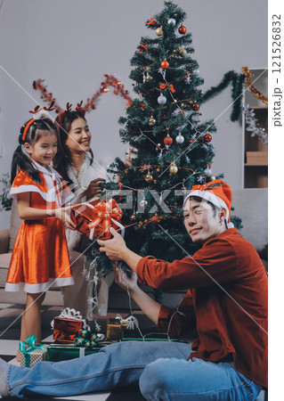 Father, mother and child celebrating Christmas. 121526832