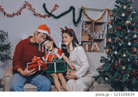 Father, mother and child celebrating Christmas. Father, mother and child celebrating Christmas. 121526834