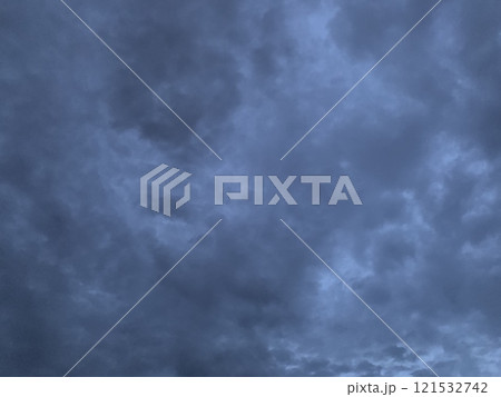 A dramatic scene of a moody evening sky filled with dark, textured clouds 121532742