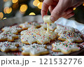 Festive Holiday Sugar Cookies with White Icing and Sprinkles 121532776