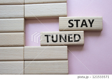 Stay Tuned symbol. Wooden blocks with words Stay Tuned Beautiful pink background. Business and Stay Tuned concept. Copy space. Stay Tuned symbol. Wooden blocks with words Stay Tuned Beautiful pink background. Business and Stay Tuned concept. Copy space. 121533571