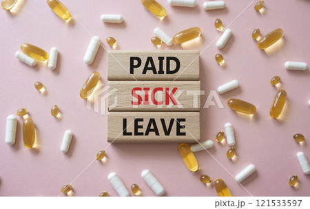 Paid Sick Leave symbol. Concept words Paid Sick Leave on wooden blocks. Beautiful pink background with pills. Healthcare and Paid Sick Leave concept. Copy space. Paid Sick Leave symbol. Concept words Paid Sick Leave on wooden blocks. Beautiful pink background with pills. Healthcare and Paid Sick Leave concept. Copy space. 121533597