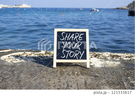 Share your story symbol. Blackboard with words Share your story. Beautiful sea background. Business and Share your story concept. Copy space. Share your story symbol. Blackboard with words Share your story. Beautiful sea background. Business and Share your story concept. Copy space. 121533617