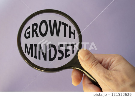 Growth Mindset symbol. Concept word Growth Mindset on magnifying glass. Beautiful purple background. Businessman hand. Business and Growth Mindset concept. Copy space Growth Mindset symbol. Concept word Growth Mindset on magnifying glass. Beautiful purple background. Businessman hand. Business and Growth Mindset concept. Copy space 121533629