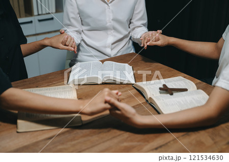 People reading and study bible in home and pray together.Studying the Word Of God 121534630