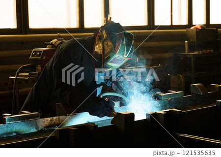 Skilled welder working diligently in a bright industrial workshop 121535635