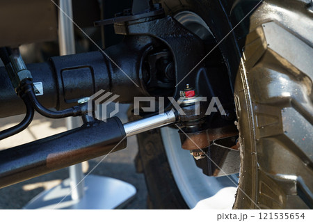 Detailed view of a vehicle's suspension system showcasing intricate parts Detailed view of a vehicle's suspension system showcasing intricate parts 121535654
