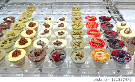 Variety of desserts with chocolate, nuts, caramel in glass. Pistachio cream and breakfast. Traditional cuisine. Variety of desserts with chocolate, nuts, caramel in glass. Pistachio cream and breakfast. Traditional cuisine. 121537479