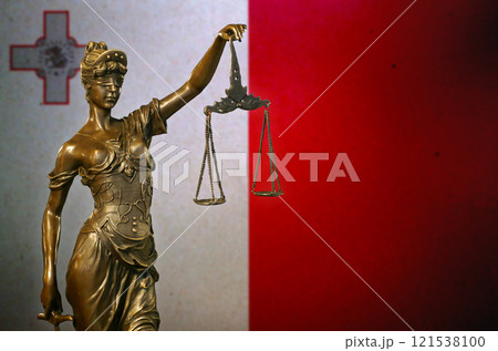 Lady Justice before a flag of Malta 121538100