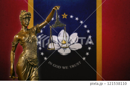 Lady Justice before a flag of Mississippi 121538110
