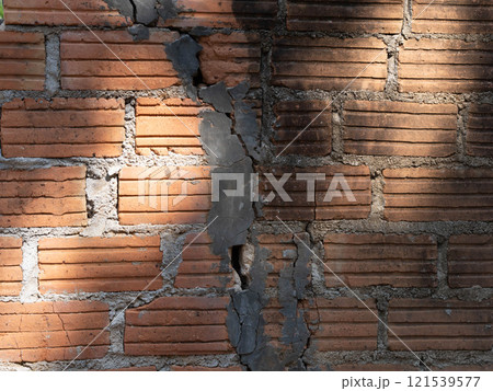 Old orange bricks and broken cement walls. Close-up of construction or repair of a wall. Old orange bricks and broken cement walls. Close-up of construction or repair of a wall. 121539577