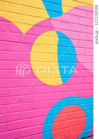Modern street art, bright graffiti on a brick wall with bright colors and geometric shapes, figures, pop art style.	 121539586