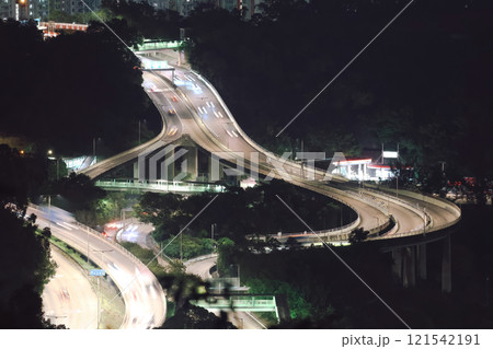 Dec 24 2024 Illuminated Highway Interchange with Nighttime City Surroundings 121542191