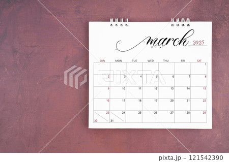 March 2025 desk calendar on red cement wall background. Page of annual monthly calendar. 121542390