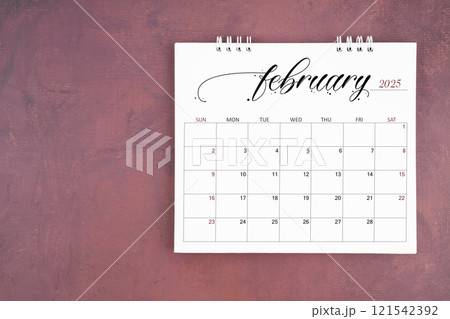 February 2025 desk calendar on red cement wall background. Page of annual monthly calendar. 121542392