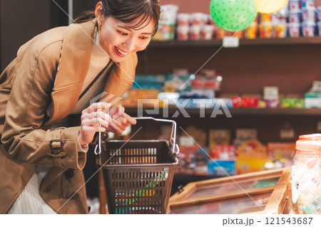 昔ながらの駄菓子屋で懐かしく買い物をする若い女性【撮影協力・お米・駄菓子屋 加賀田米穀店】 昔ながらの駄菓子屋で懐かしく買い物をする若い女性【撮影協力・お米・駄菓子屋 加賀田米穀店】 121543687