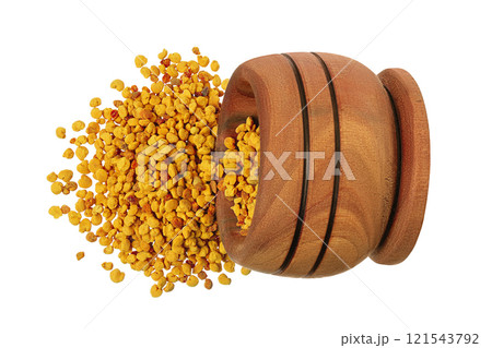 Bee pollen grains in wooden bowl isolated on white background. Top view. Flat lay 121543792