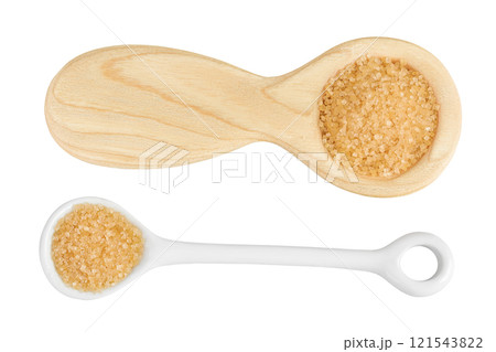 The brown sugar in ceramic and wooden spoon isolated on white background. Top view. Flat lay The brown sugar in ceramic and wooden spoon isolated on white background. Top view. Flat lay 121543822