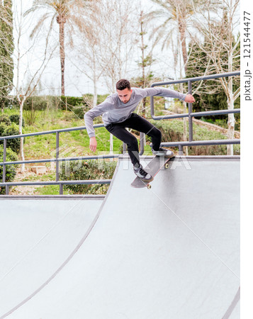 Young Skateboarder Performing Trick at Skatepark. 121544477