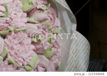 A bouquet of marshmallows. Zephyr flowers. Packed in craft paper. Close-up. 121544608