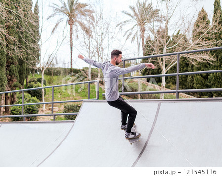 Young Skateboarder Performing Trick at Skatepark. Young Skateboarder Performing Trick at Skatepark. 121545116