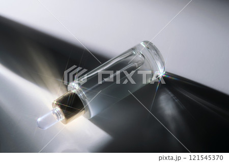 Bottle of face serum with a pipette with a beautiful highlight. Bottle of face serum with a pipette with a beautiful highlight. 121545370