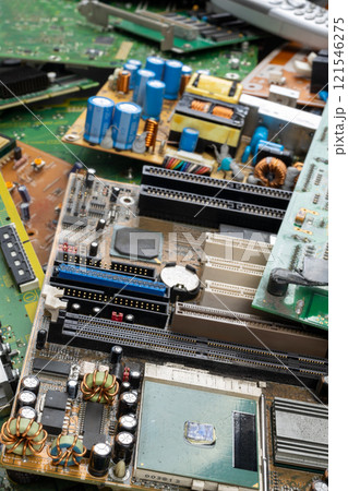 Discarded Circuit Boards Highlighting Electronic Waste and Overproduction 121546275