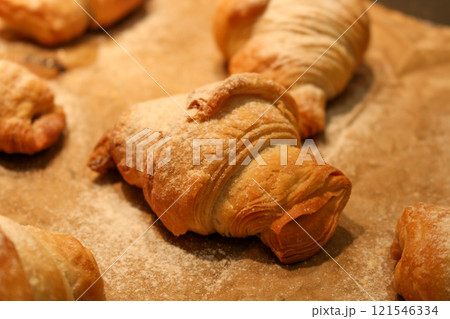 golden chocolate croissant on parchment paper close up golden chocolate croissant on parchment paper close up 121546334