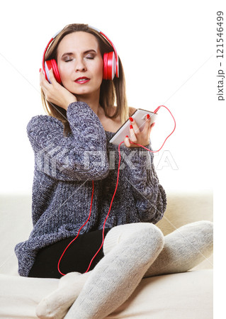 Woman with headphones listening music 121546499
