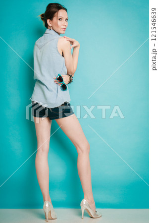 Summer fashion girl in jeans shirt shorts and high heels. 121546639