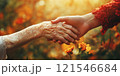 Older female and young woman holding hands 121546684