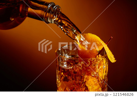 Whiskey or bourbon pouring into a crystal glass. Whiskey or bourbon pouring into a crystal glass. 121546826