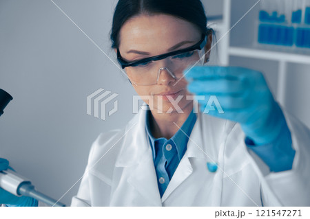 In a cuttingedge lab merging biotechnology and chemistry, a skilled scientist examines a sample with innovative methods, potentially leading to groundbreaking healthcare discoveries In a cuttingedge lab merging biotechnology and chemistry, a skilled scientist examines a sample with innovative methods, potentially leading to groundbreaking healthcare discoveries 121547271
