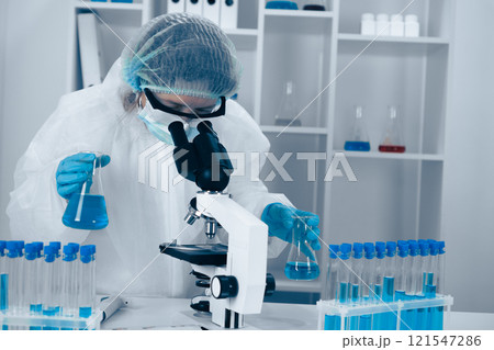 A dedicated scientist diligently engaged in extensive research utilizing advanced laboratory equipment and sophisticated microscopy techniques to conduct critical experiments and analyze data A dedicated scientist diligently engaged in extensive research utilizing advanced laboratory equipment and sophisticated microscopy techniques to conduct critical experiments and analyze data 121547286