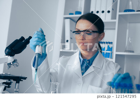 A passionate female scientist is conducting a groundbreaking experiment in a stateoftheart lab, showcasing her commitment to cuttingedge research in biochemistry and microbiology A passionate female scientist is conducting a groundbreaking experiment in a stateoftheart lab, showcasing her commitment to cuttingedge research in biochemistry and microbiology 121547295