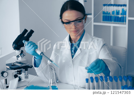 Laboratory Research A dedicated scientist is meticulously conducting various experiments using a micropipette and an array of test tubes to advance our understanding in the field of science Laboratory Research A dedicated scientist is meticulously conducting various experiments using a micropipette and an array of test tubes to advance our understanding in the field of science 121547303