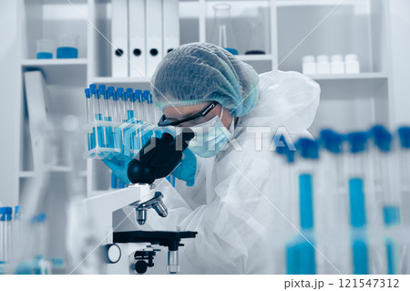 A dedicated Research Scientist is analyzing samples in a hightech lab, using advanced techniques and sophisticated equipment for extensive research across multiple scientific fields A dedicated Research Scientist is analyzing samples in a hightech lab, using advanced techniques and sophisticated equipment for extensive research across multiple scientific fields 121547312