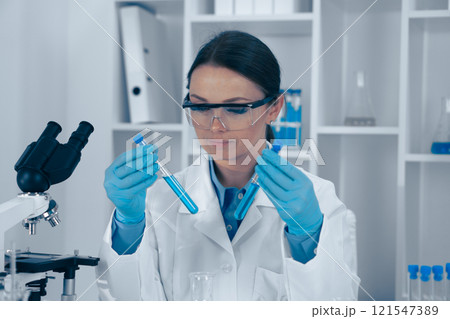 Scientist Analyzing Samples in a Modern Laboratory Setting Scientist Analyzing Samples in a Modern Laboratory Setting 121547389
