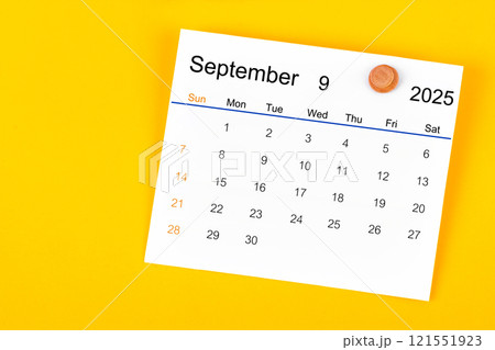 September 2025 and wooden push pin on yellow. 121551923